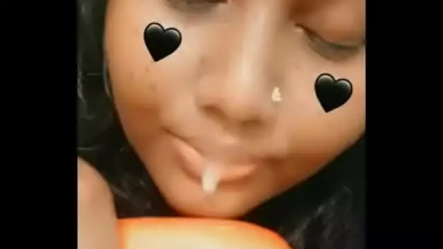 some indian girl sucking a carrot