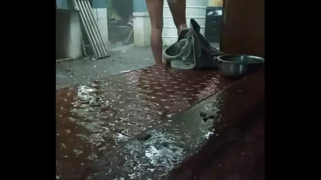 Indian boy bathing in rain